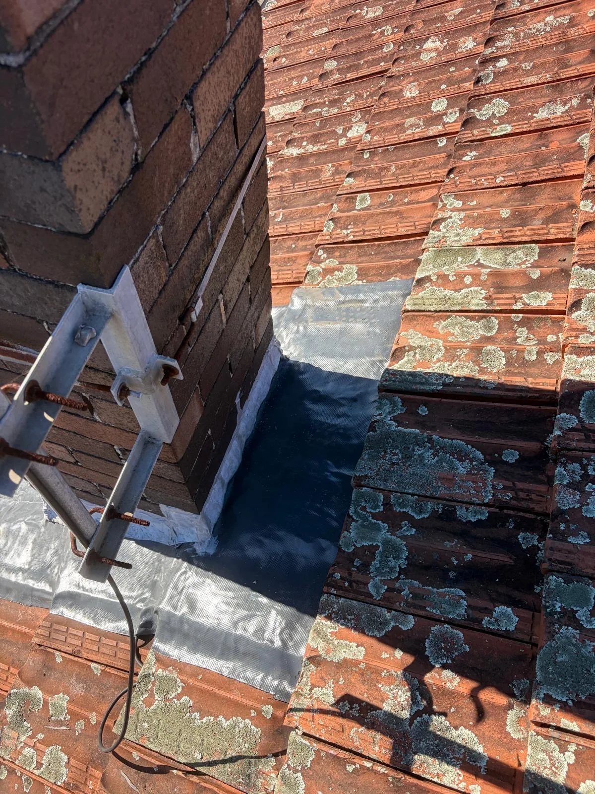 Lead flashing against heritage brickwork on a chimney