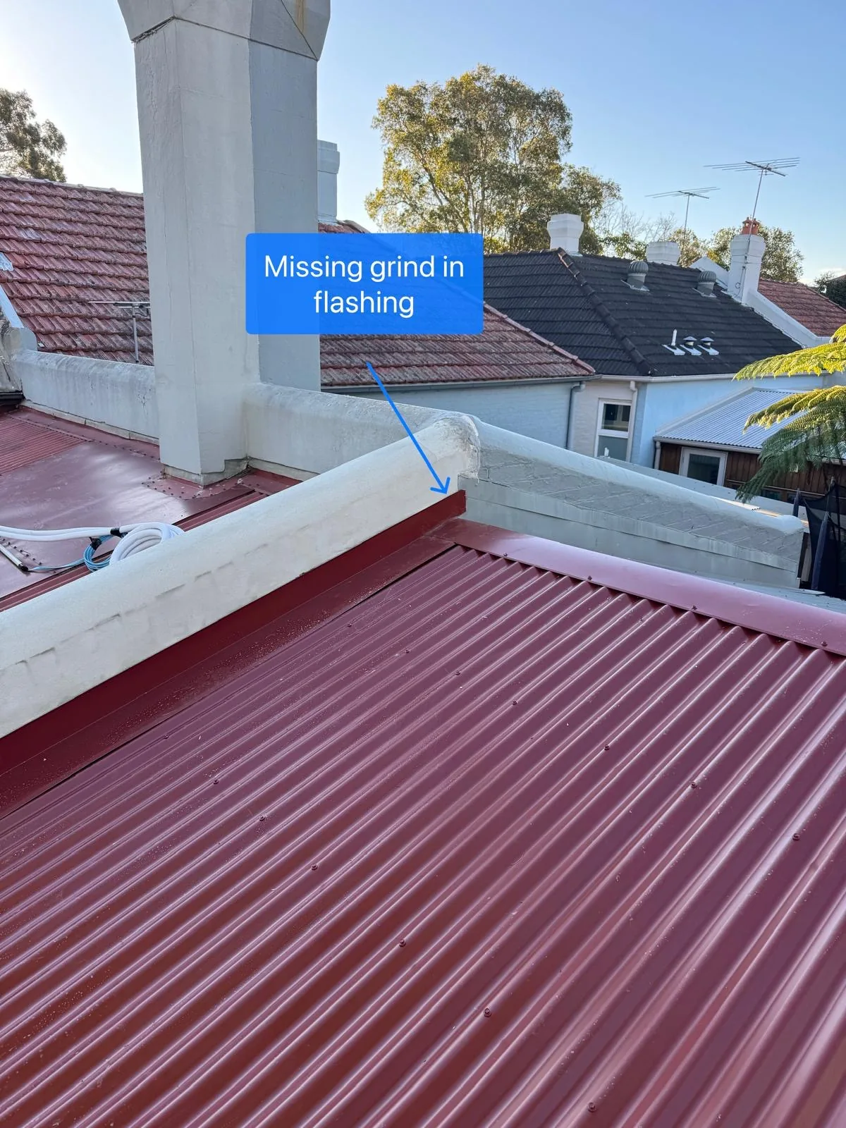 New flashing along a corrugated metal roof and parapet