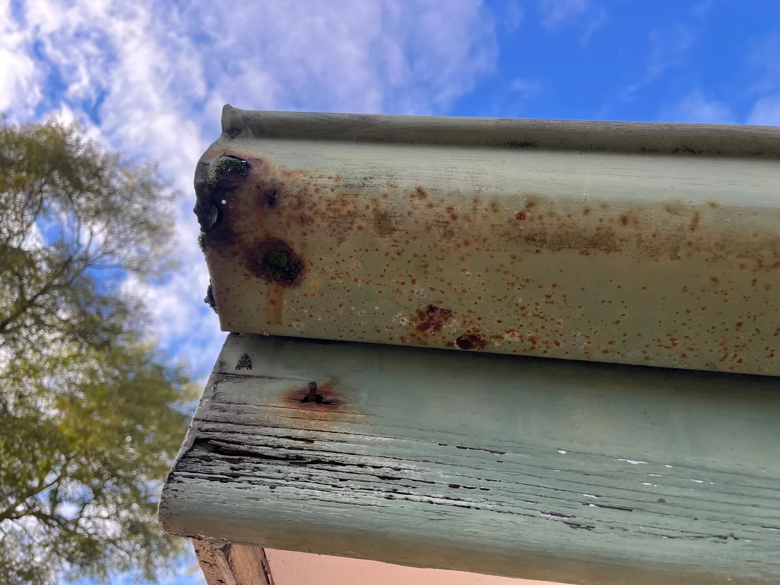 Severe rust perforation in an old metal gutter