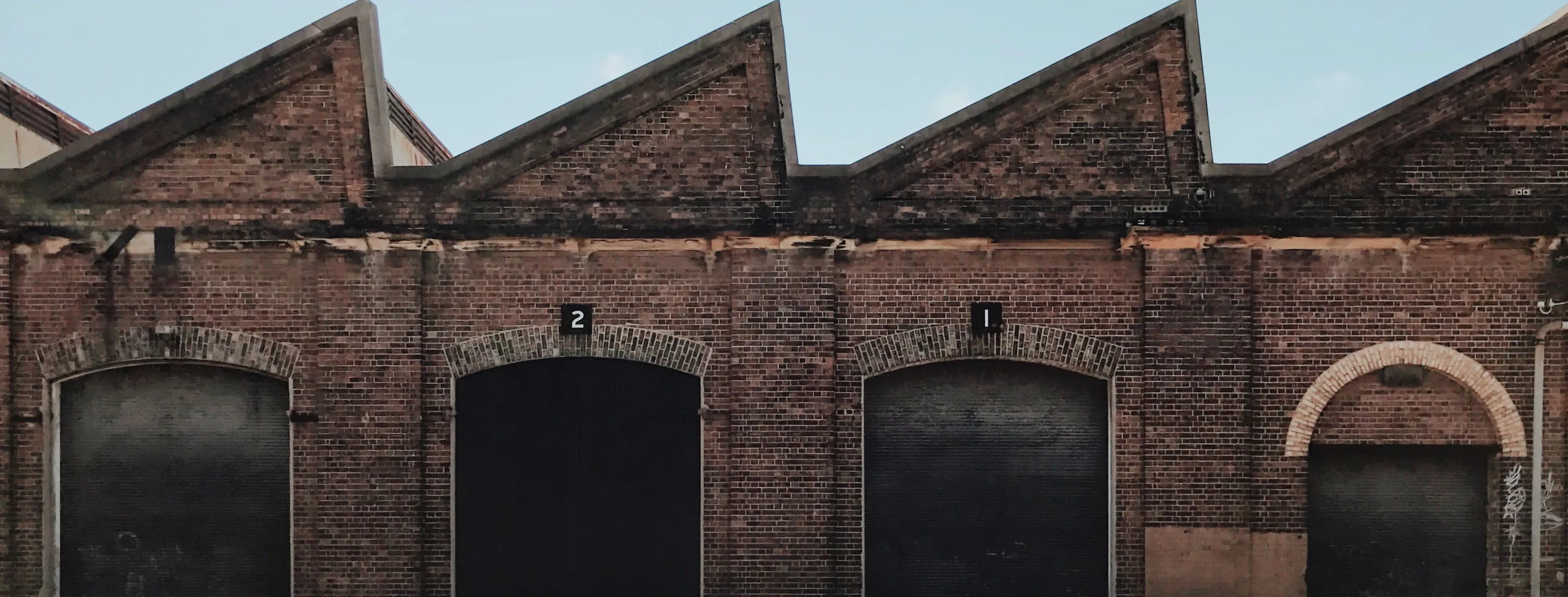 Sawtooth roof of a converted brick warehouse in inner Sydney