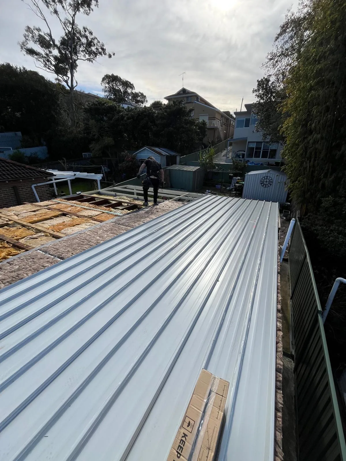 New metal roof sheets laid along a terrace roof