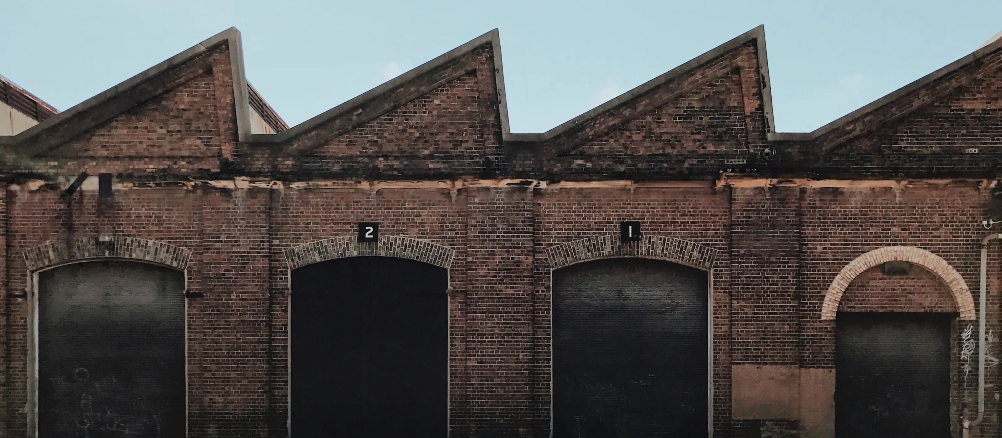 Sawtooth roof of a converted brick warehouse in inner Sydney