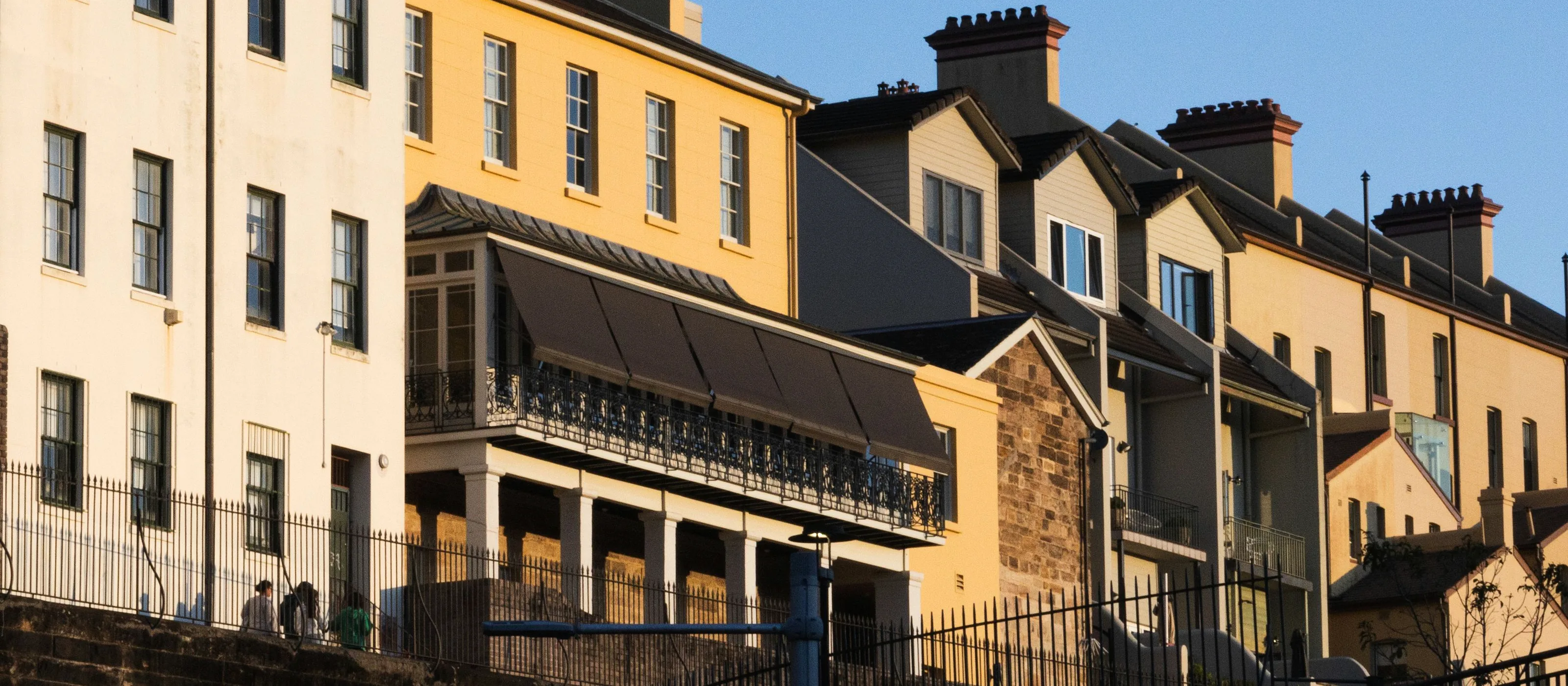 Row of historic Sydney terrace houses with chimneys and pitched roofs