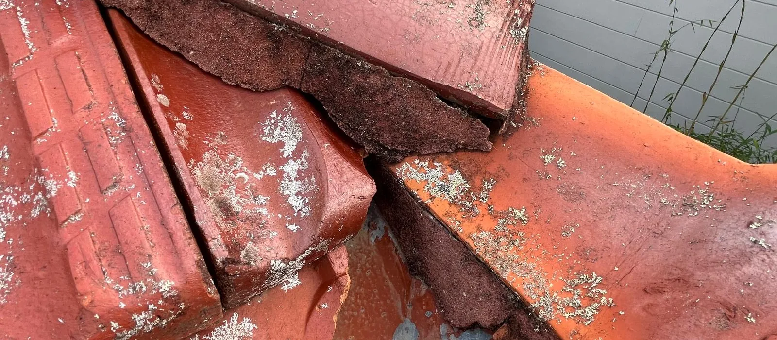 Broken terracotta ridge tiles and perished bedding mortar