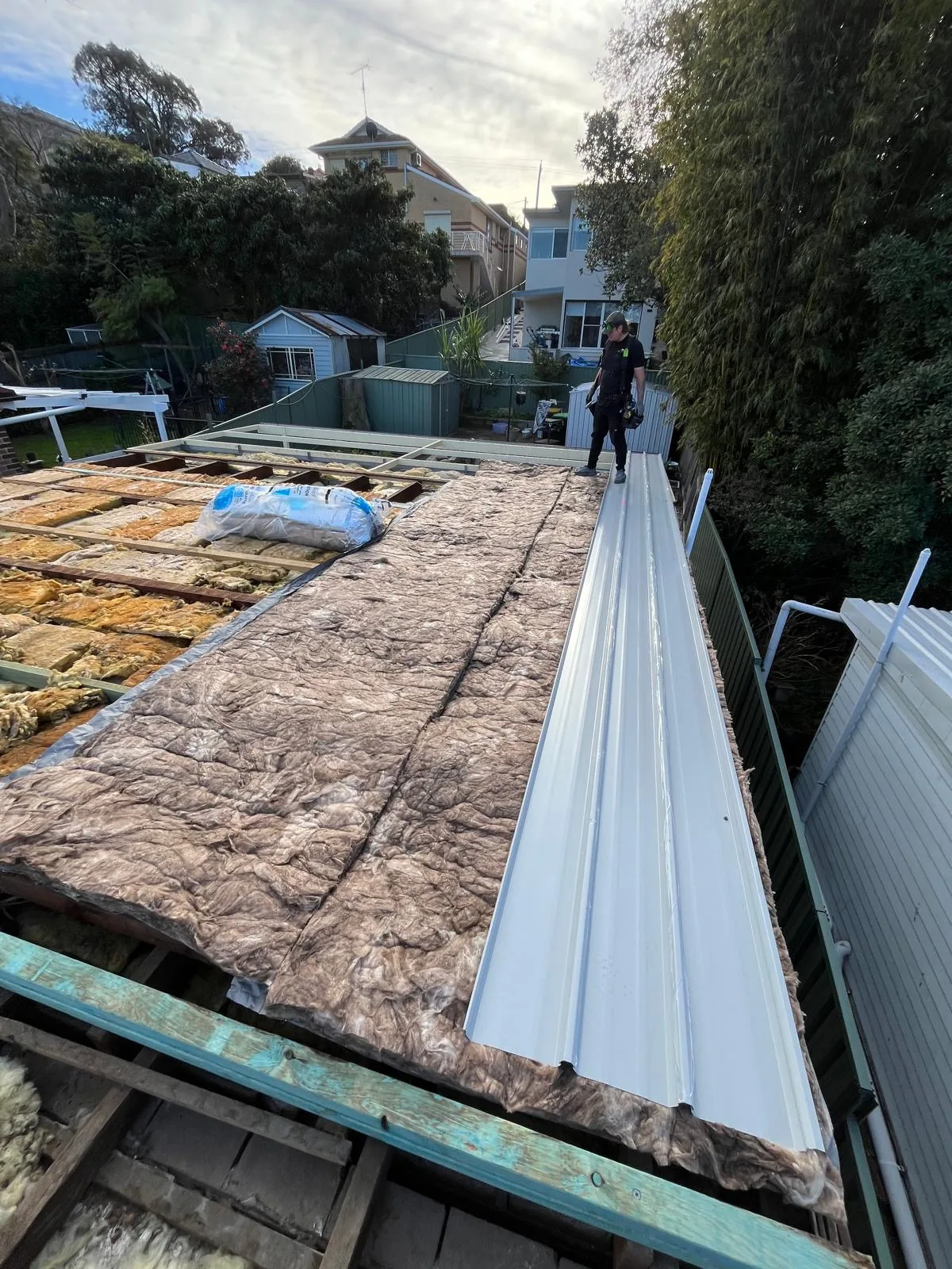 New Colorbond sheeting going on over stripped battens