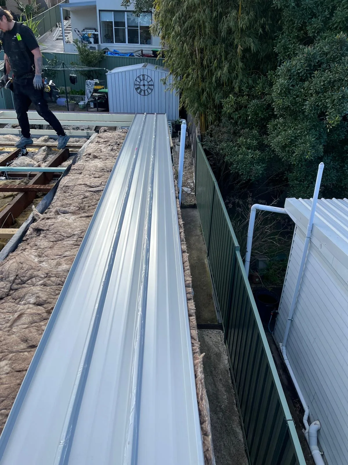Colorbond roof sheets being laid on a terrace roof