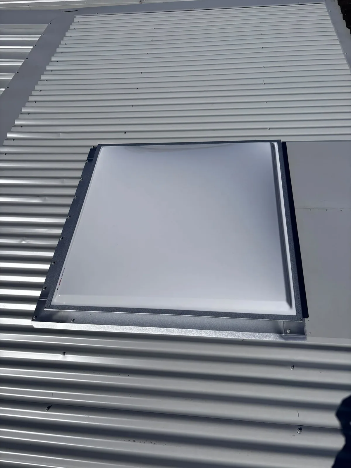 Skylight flashed into a new metal roof