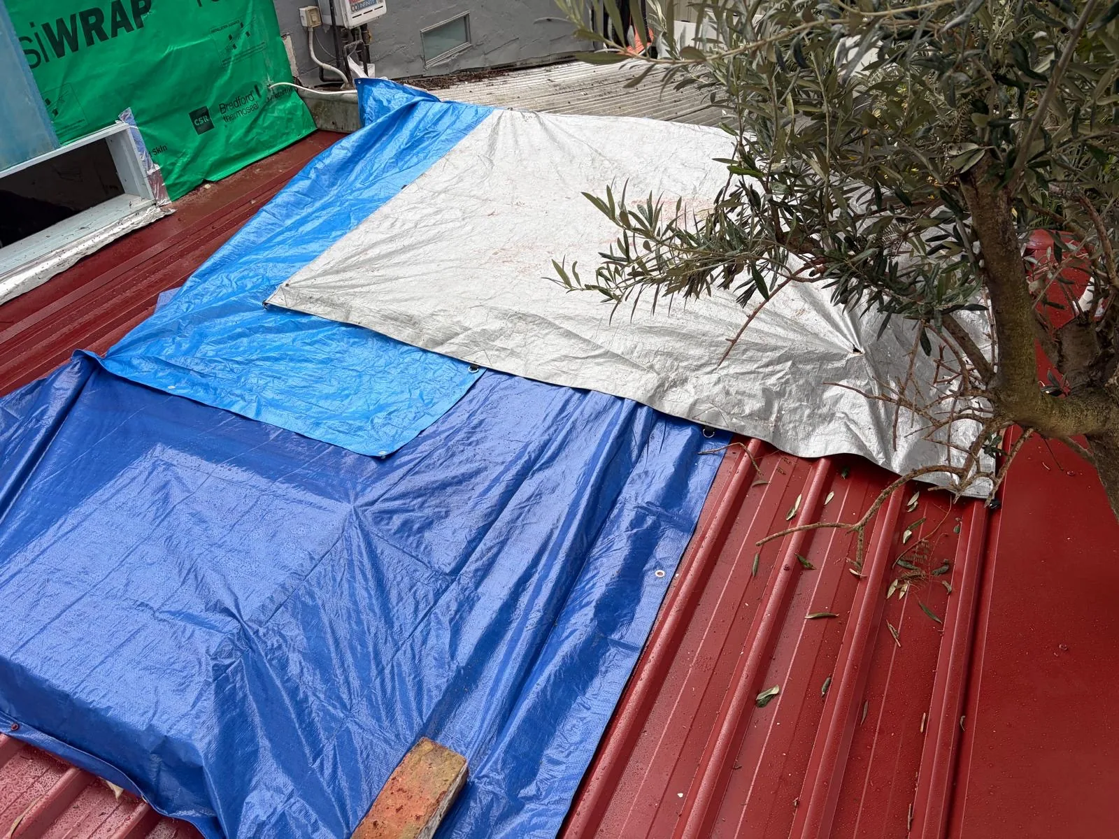 Temporary tarpaulins covering an exposed roof during works