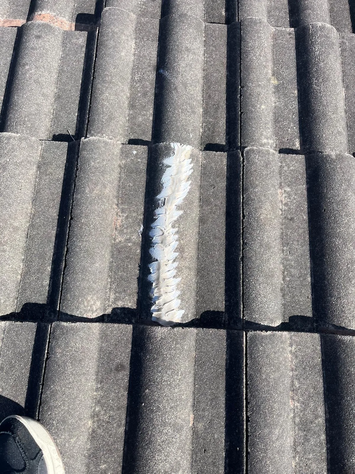 Close view of concrete roof tiles with fresh pointing